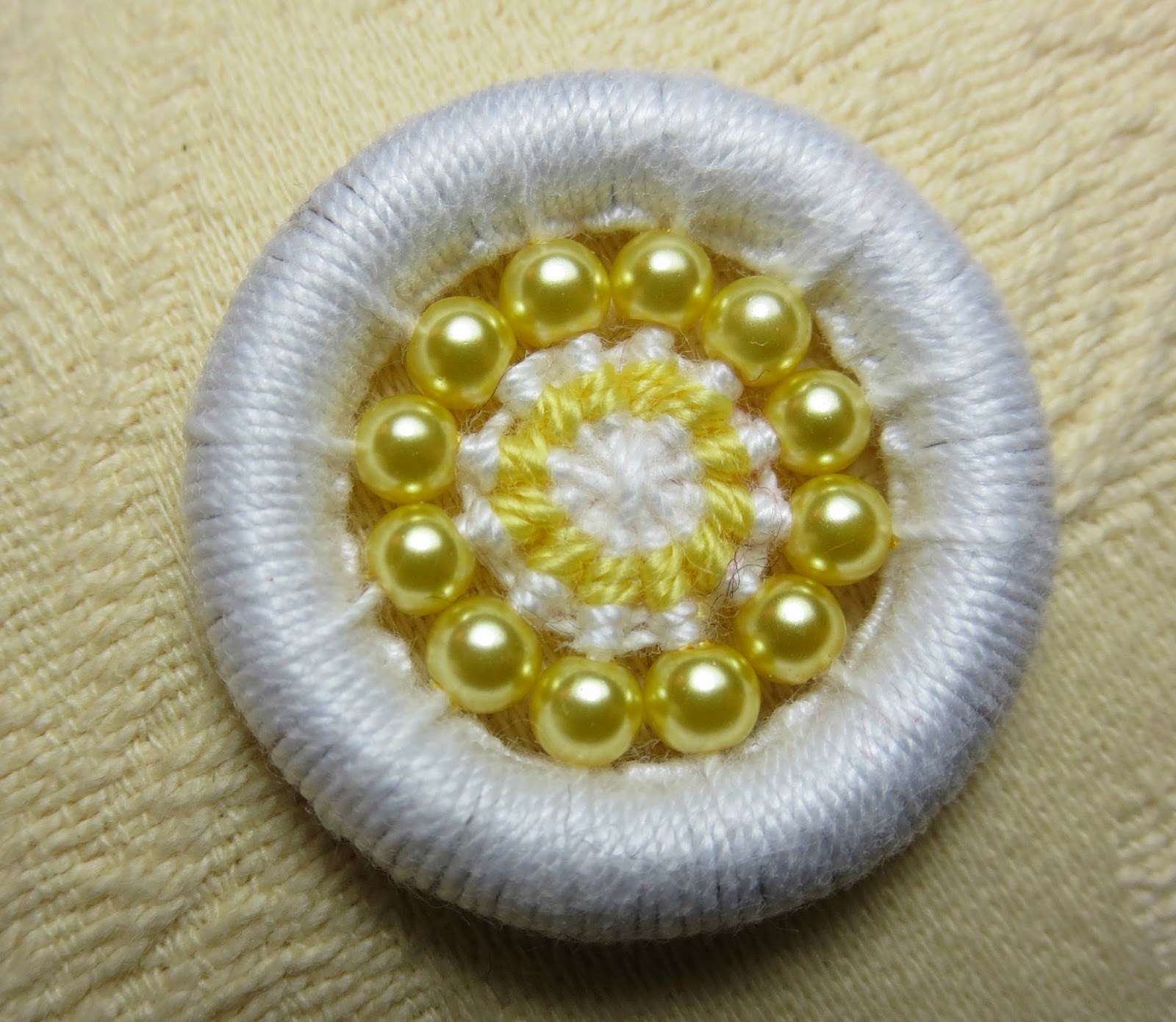 Yellow and white beaded dorset button