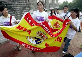 Real Madrid's China fans with a flag of the Spanish team