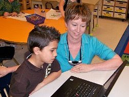 Ms. Cassidy helping a student on the computer