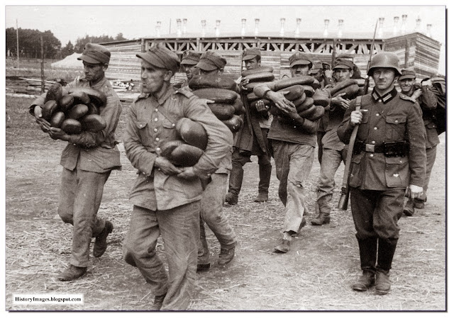 Polish POW carry loaves of bread escorted  German soldier