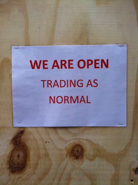 a sign on a wood surface