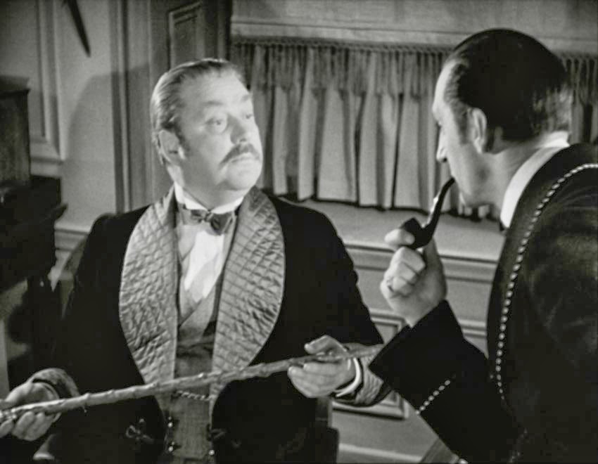 Dr. Watson (Nigel Bruce), examining Dr. Mortimer's stick left behind in The Hound of the Baskervilles, as overseen by Sherlock Holmes (Basil Rathbone)