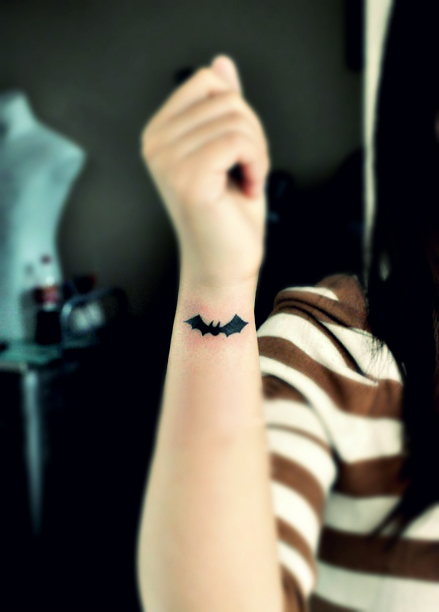 little black bat tattoo on the wrist