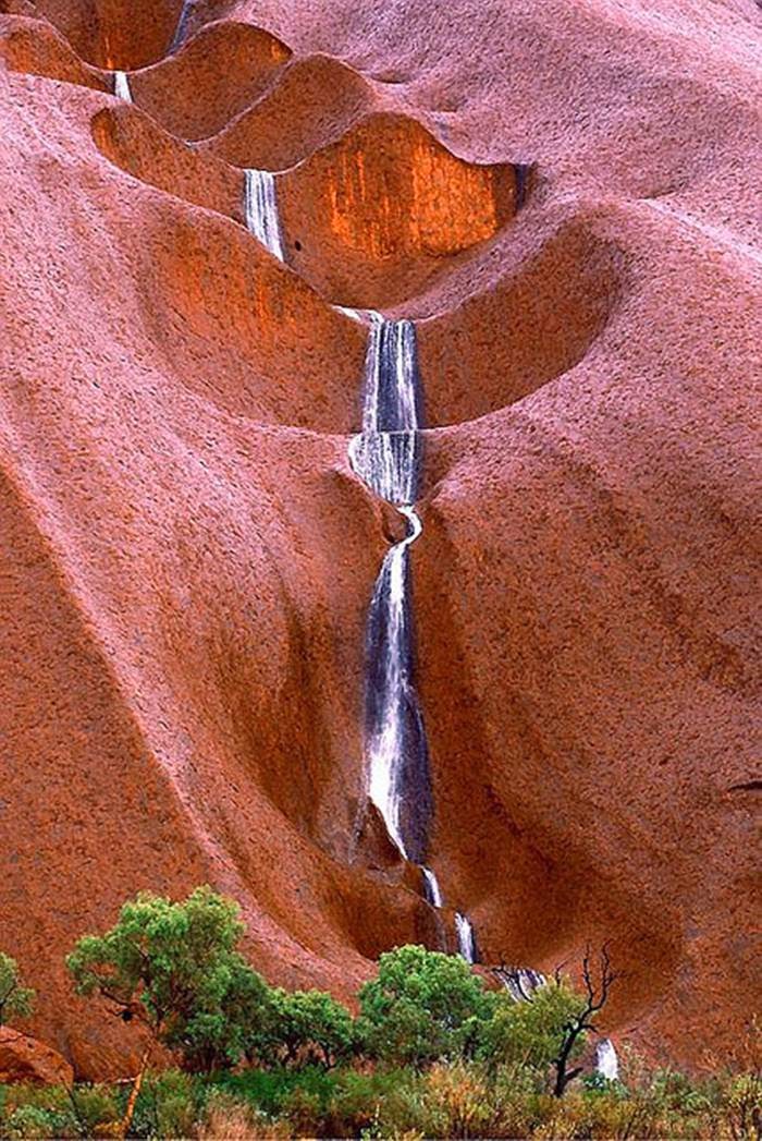 Uluru Waterfalls ─ Australia It lies 335 km south west of the nearest large town, Alice Springs, 450 km by road. Kata Tjuta and Uluru are the two major features of the Uluru-Kata Tjura National Park.