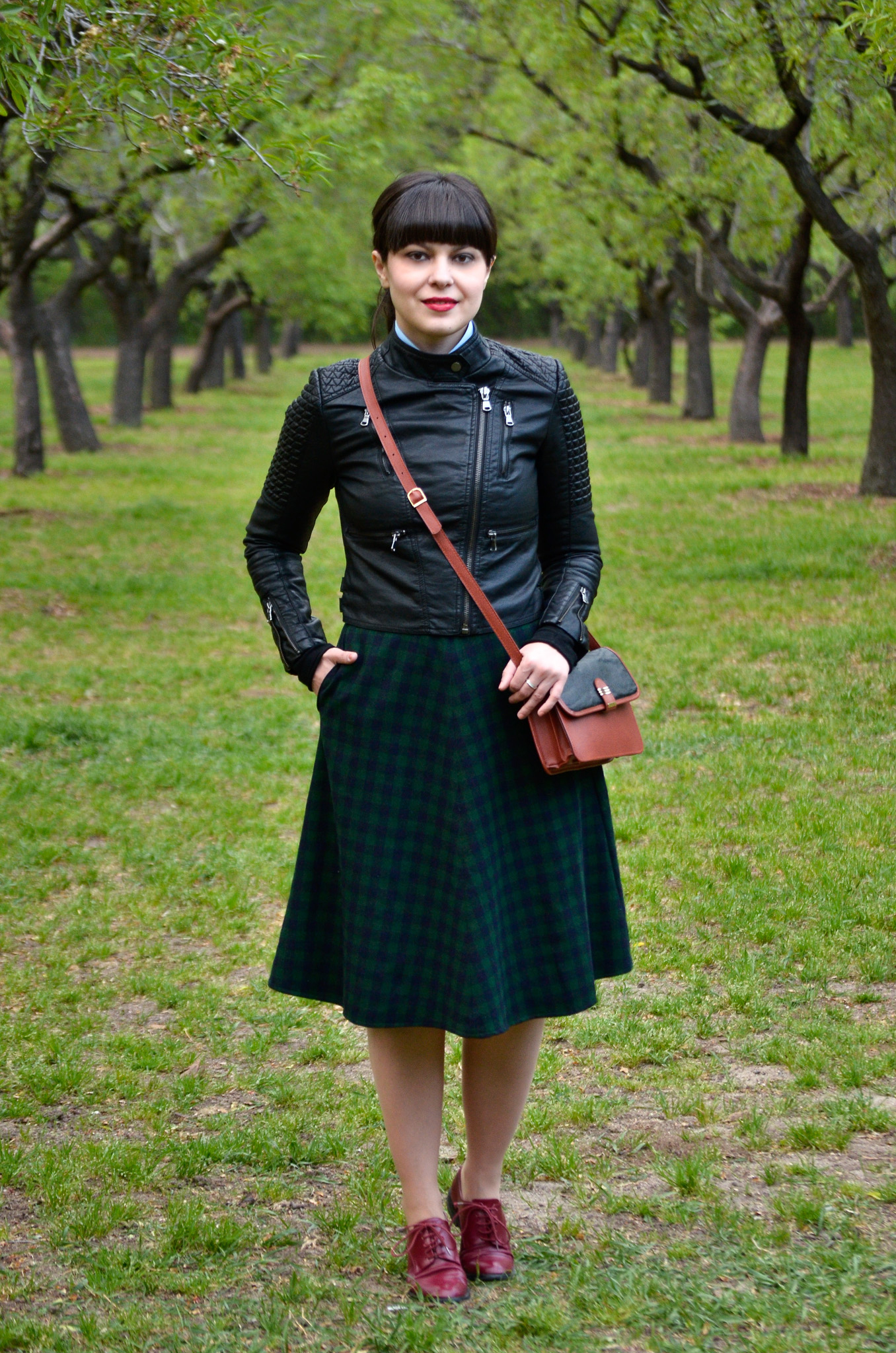 school girl outfit in madrid green tartan midi skirt thrifted brown bag satchel sky blue shirt black bow tie bangs burgundy oxford shoes poema spring green fresh park