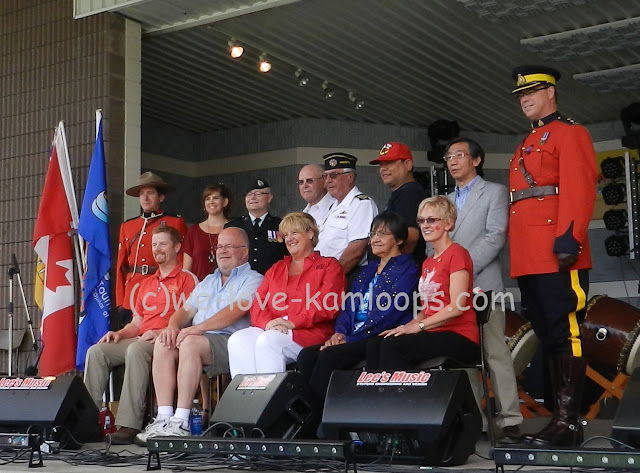 Photographer is taking pictures of the dignitaries involved in the opening ceremonies of Canada Day in Riverside Park