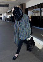 Ashley Olsen covers her face with a bag