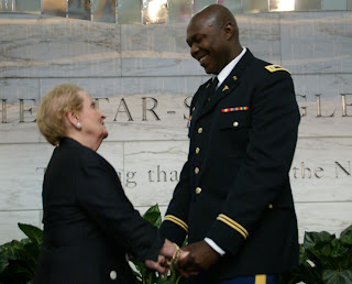 Madeleine Albright, former Secretary of State, greets new U.S. citizen Olugbenga Olufemi Obasanjo (U.S. Army)