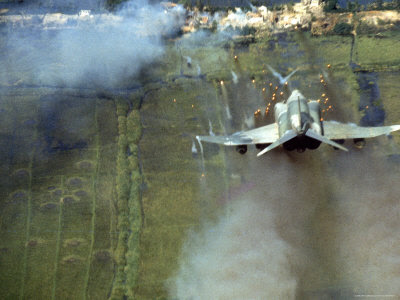 larry-burrows-american-f4c-phantom-jet-firing-rockets-into-viet-cong-stronghold-village-during-the-vietnam-war.jpg