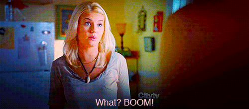Animated gif of a woman throwing up her hands and saying "What? BOOM!"