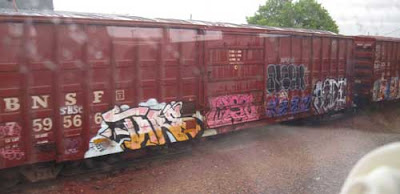 Gondola train cars with colorful graffiti