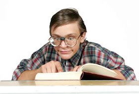 [un ragazzo intelligente con gli occhiali studia leggendo un libro]