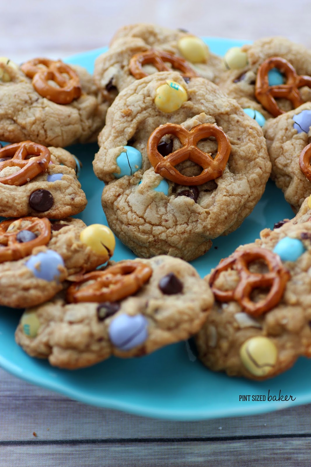 Love sweet and salty? You're gonna love these M and M Pretzel Chocolate Chip Cookies! Easy cookies with salty pretzel M&M's and a pretzel on top!