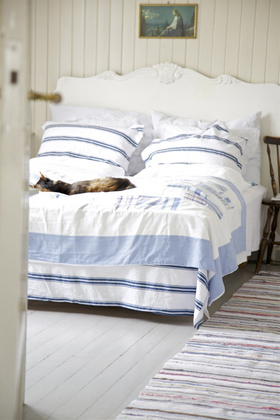 Stripe bed linens and shabby coastal decor