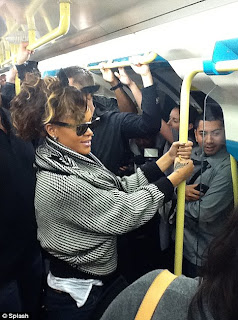 Pictures Of Rihanna riding the London tube with her fans: Damn she couldnt even get a seat. 5