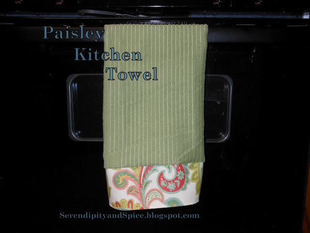 blog+049 Paisley Kitchen Towel Ooooh, I feel like Spring is almost here!</p> Don't you feel it?!</p>  
I love the warmer weather, the sunny days, the April showers, the May flowers, yard sale finds, flea market browsing, craft fair inspirations, oh the list goes onand on!</p> This fabric makes me think Spring!</p> This kitchen towel was super easy and super cheap to make!  I used a bar mop towel from the Dollar Tree and some leftover fabric from my Paisley Oven Mitt. For some crazy reason I didn't take pictures of the process but... All you do is cut about 6 inches of fabric.  Measure the width to fit the towel, leaving about 1/2 inch on each end for the hem.  Just hem each edge and the bottom of the fabric strip.  Then attach to the end of the towel.  I added the fabric embellishment to both ends of the towel. That's it!  Easy Peasy!! Don't you just LOVE this set!