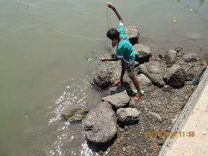 Young villager "Crab Fishing" at Veshvi Jetty.