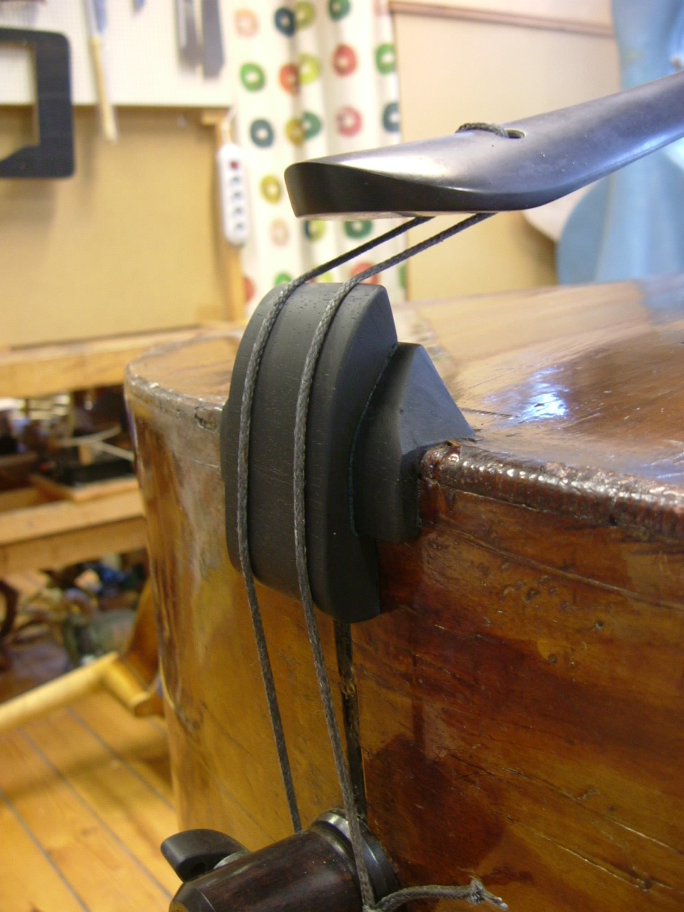 Bass Care Instrument Repair Raising the saddle on a double bass to lessen the string angle.