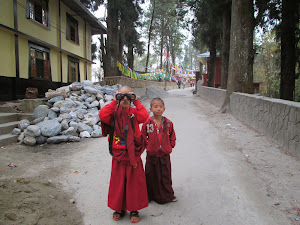 Child Buddhist students  using my binoculars.