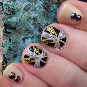 Art Deco inspired nail art using striping tape, glitter, and rhinestones.