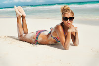 Sylvie van der Vaart on the sandy beach in a tiny bikini