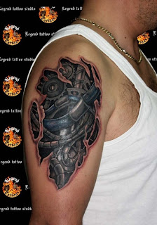 biomechanical tattoo on the shoulder and upper arm