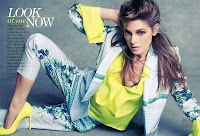 Ashley Greene in  a yellow shirt and heels on the floor