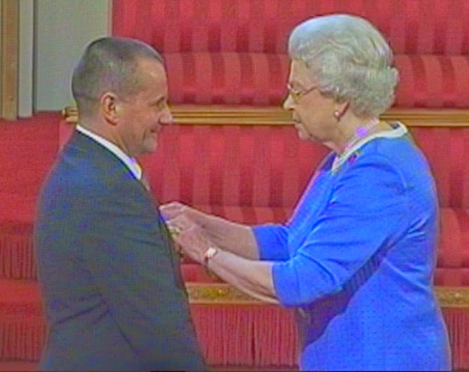 Queen Elizabeth presents M.B.E.