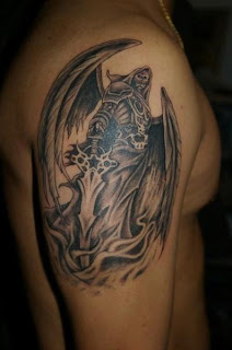 shoulder tattoo / upper arm tattoo: Grim Reaper / Angel of Death portrayed as a winged warrior-skeleton