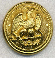 Photo of a Civil War era Union Army button, brass colored, with engraving of an eagle
