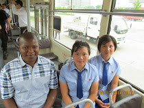 Banele Nyamane of Malawi on public tram in Pyongyang, with a couple of friendly local "props"