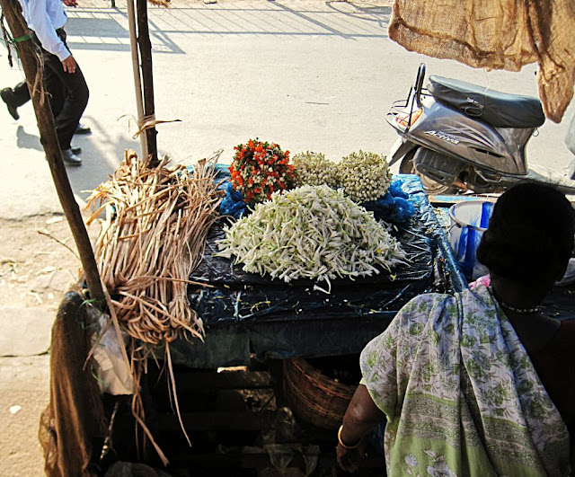 woman selling white flowers