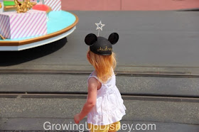little girl watching a Disney parade
