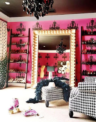 Miley Cyrus' Shoe Closet This closet room is outfitted with fantastic accents like a black chandelier, a comfy chair, gold framed mirrors, cool wall decals and ladder bookcases for shelving.