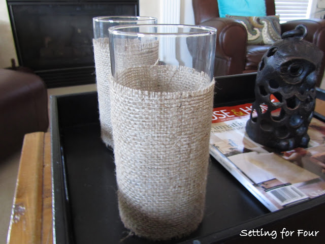 See this Quick and Easy way to dress up your hurricane candle holders with burlap! DIY Burlap Hurricane Sleeve with easy tutorial and supply list included.