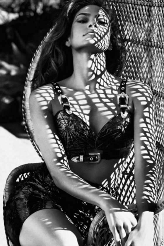 EVA MENDES in a bra sitting in a chair, black and white photo