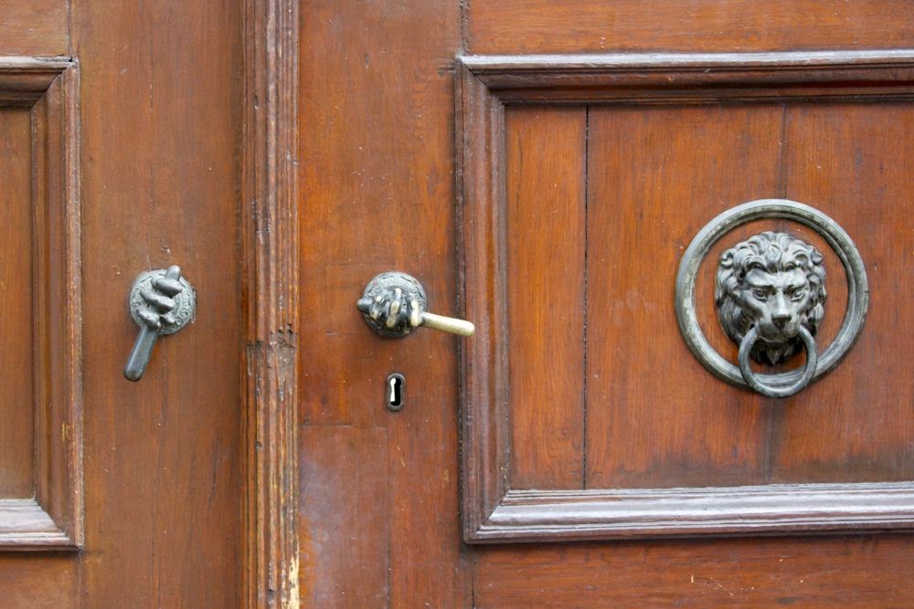 brown door with hands as handles