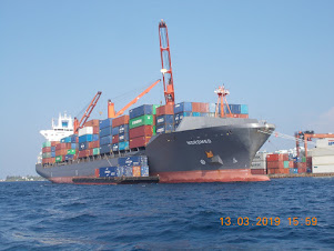 Container ship "Nordmed" discharging cargo onto a barge.