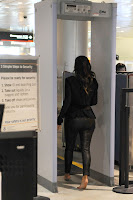 Kim Kardashian walking barefoot through the check point at Miami Airport 