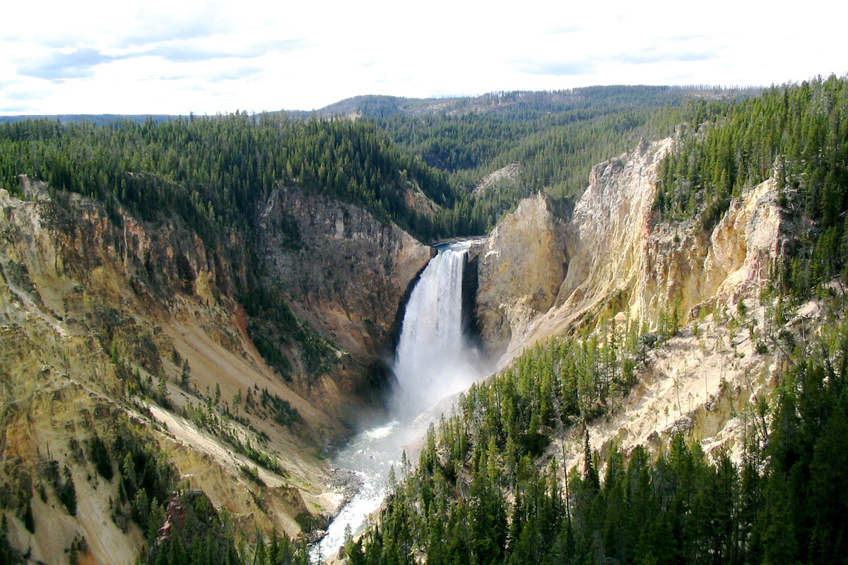 yellowstone national park Located primarily in the state of wyoming, yellowstone national park sits atop an enormous, slumbering supervolcano and is home to half of the world's geysers from a 300-foot-tall waterfall. yellowstone national park Located primarily in the state of wyoming, yellowstone national park sits atop an enormous, slumbering supervolcano and is home to half of the world's geysers from a 300-foot-tall waterfall.