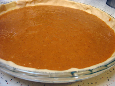 Uncooked pumpkin pie filling in crust.