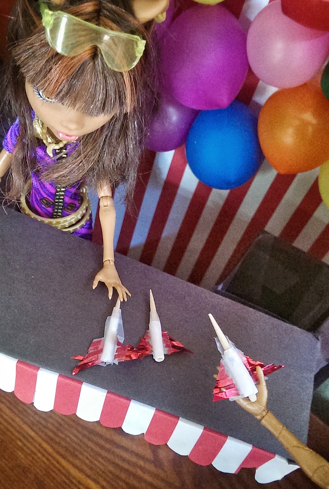 Craft a doll carnival booth from cereal boxes