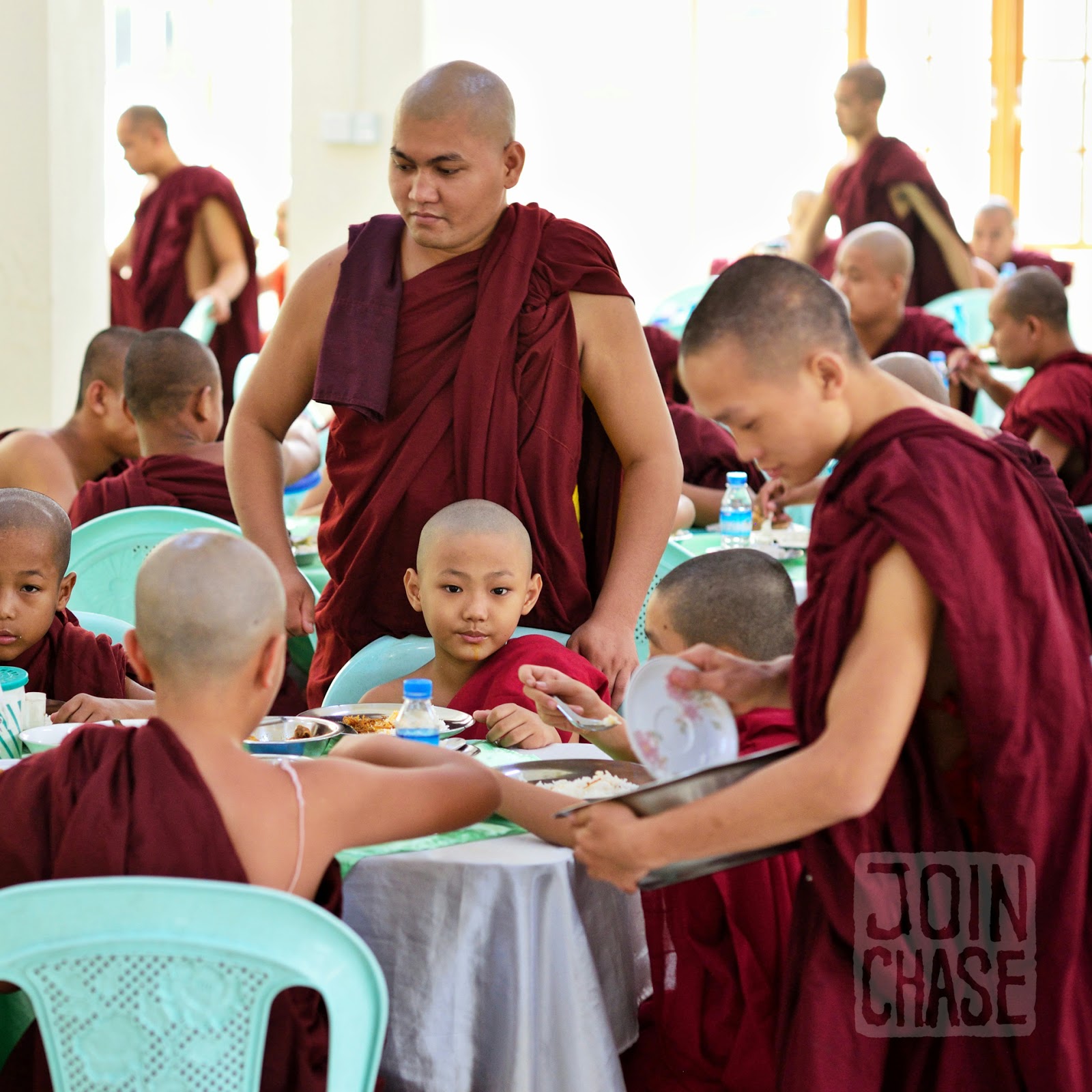 Novice monks eating lunch together during Thingyan in Yangon, Myanmar.