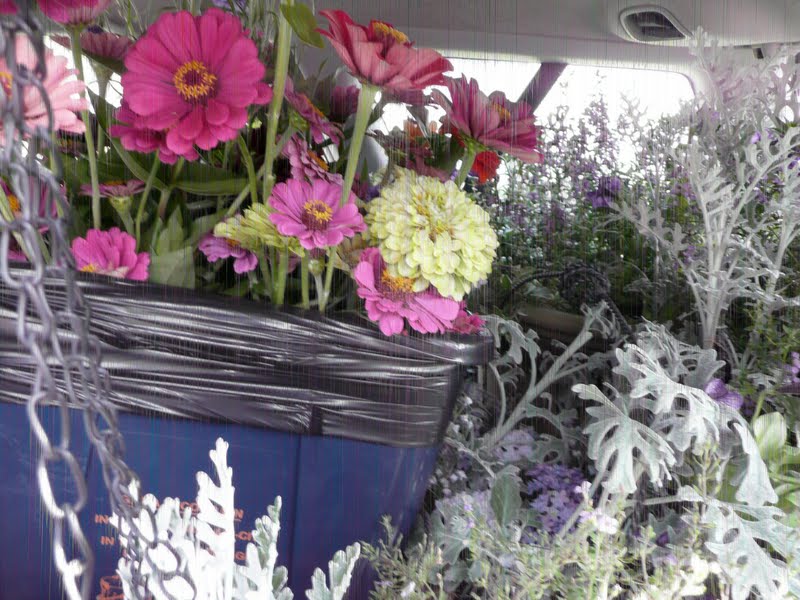 The car is loaded with wedding flowers