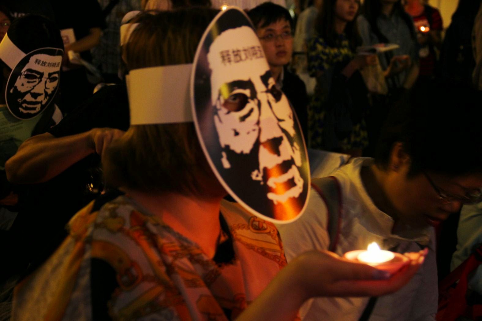中國維權人士陳光誠今(4)晚透過音帶的方式,跨海聲援在中正紀念堂自由廣場舉辦的「六四X二十四晚會」,民眾戴起劉曉波的面具、手捧蠟燭,表達弔念之意。圖:周思宇/攝 中國維權人士陳光誠今(4)晚透過音帶的方式,跨海聲援在中正紀念堂自由廣場舉辦的「六四X二十四晚會」,民眾戴起劉曉波的面具、手捧蠟燭,表達弔念之意。圖:周思宇/攝