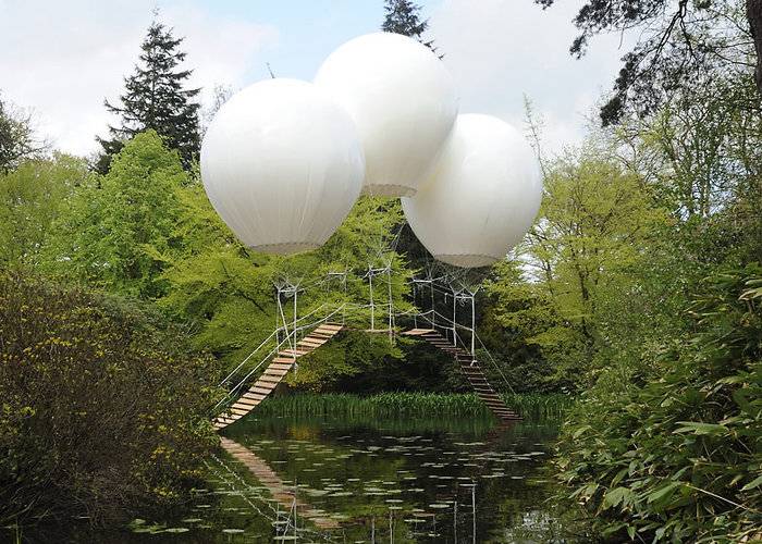French artist Olivier Grossetête used three enormous helium balloons to float a rope bridge over a lake in Tatton Park, a historic estate in north-west England. Oliver Grossetête created Pont de Singe, which means "monkey bridge", for the Tatton Park Biennial, which this year was themed around flight. Located in the park's Japanese garden, the structure comprised a long rope bridge made of cedar wood held aloft by three helium-filled balloons. The ends of the bridge were left to trail in the water. Though visitors weren't allowed to use the bridge, it would theoretically be strong enough to hold the weight of a person, according to Grossetête.