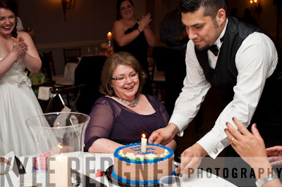 Bride's mother being presented with a birthday cake