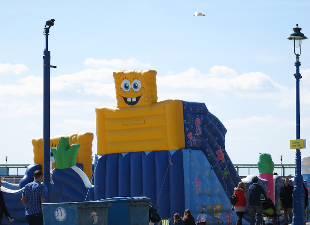 Gull flies over bouncy castle with face and teeth. ©Lucy Corrander. 
