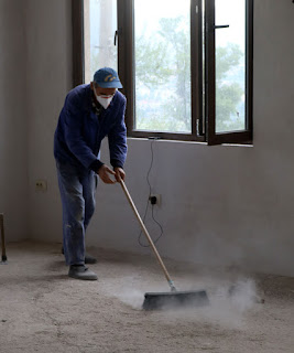 Sally, with mask, sweeping the floor Sally, with mask, sweeping the floor