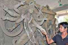 An artisan is trying to repair the broken hand of the clay image of Goddess Durga as some unidentified muslim miscreants damaged it at a temple in Khulna city on Friday.